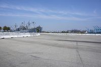 an empty parking lot surrounded by industrial docks and seaplanes are seen here in this image