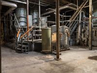 an old, dusty industrial building with multiple pipes and equipment to use as storage space