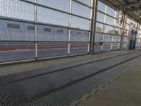 an industrial steel grate with a man walking on the side in front of it