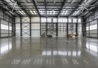 an empty room with an open floor and several workers on the sidelines working on hard surfaces