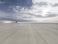 an airport that is set on top of a platform with blue sky above it and mountains in the background