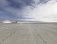 an airport that is set on top of a platform with blue sky above it and mountains in the background