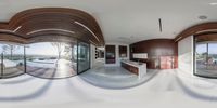 the circular view of a living room, dining area and kitchen shows the views outside