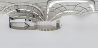 a white room with circular lighting on it and concrete floors inside and under the roof