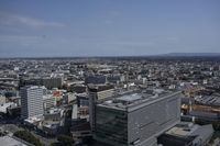 the city is very crowded with buildings and some planes flying by on the skies above