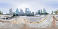 a view of a city from the back of a ramp and its surrounding area of construction, with a very wide angle