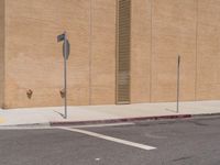 a stop sign sits in the middle of an empty street corner next to a brick building