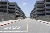 a view of the empty city street in front of several parking garages with an arrow showing 2018