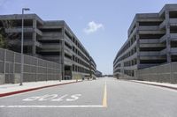 a view of the empty city street in front of several parking garages with an arrow showing 2018