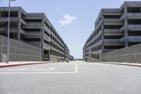 a view of the empty city street in front of several parking garages with an arrow showing 2018