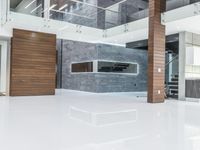 a room with a large open floor plan in the building with white floors and high ceilings