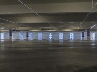 an empty building in the middle of a parking space with high ceilings and windows and no doors