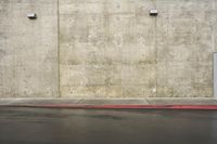 a man walking in front of a wall with a fire hydrant near by him