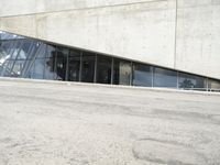the rear end of a building that's being used for skateboarding riding, with a window on one of the sides
