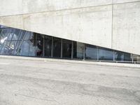the rear end of a building that's being used for skateboarding riding, with a window on one of the sides