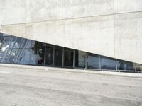 the rear end of a building that's being used for skateboarding riding, with a window on one of the sides