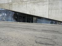 the rear end of a building that's being used for skateboarding riding, with a window on one of the sides