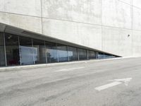 the rear end of a building that's being used for skateboarding riding, with a window on one of the sides