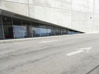 the rear end of a building that's being used for skateboarding riding, with a window on one of the sides