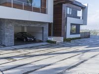 the exterior and landscape of a modern house in los angeles, california with stone and wood