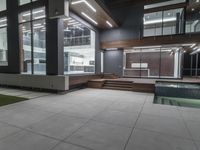 the modern home features a large courtyard pool and terraces in front of large glass walled windows