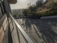 the exterior and landscape of a modern house in los angeles, california with stone and wood