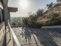 the exterior and landscape of a modern house in los angeles, california with stone and wood