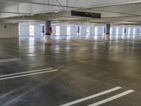 parking garage with empty spaces and white markings on the floor and walls on the floor