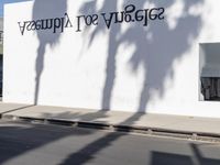 a person riding on a motorcycle next to a wall with writing on it and the words semagy, sort aquaquessy