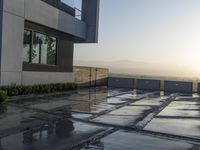 an outdoor patio overlooking the mountains with water running on it and some concrete slabs underneath