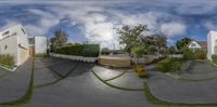 a view of a modern residential area through a fisheye lens of a parking lot