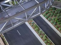 a view of a road and an overpass with traffic passing through it by buildings