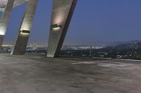 the parking lot features concrete columns and high tech lighting as well as a city view