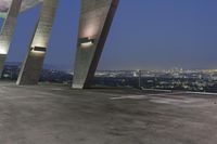 the parking lot features concrete columns and high tech lighting as well as a city view