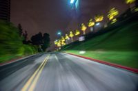 blurry shot from a vehicle with the city lights in the background at night on a street