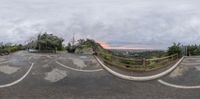 a fisheye lens photo taken from a parking spot at the top of a hill