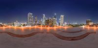 this view shows the illuminated city lights of a large area with skateboards, skating ramps and lights