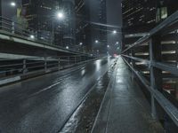 a very dark city street with a bridge near it and some cars at night as if on the road