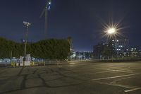 a parking lot filled with lots of parking space at night with the sun in the sky