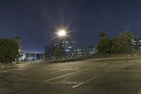 a parking lot filled with lots of parking space at night with the sun in the sky