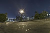 a parking lot filled with lots of parking space at night with the sun in the sky