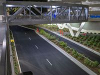 a view of a road and an overpass with traffic passing through it by buildings