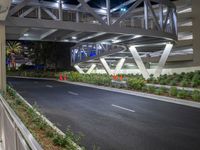 a view of a road and an overpass with traffic passing through it by buildings