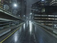 rainy night in the city at street level with road and bridge lighting up the night sky