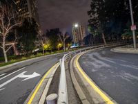 a night time shot of a road with a street light and buildings on the horizon