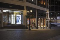 this is a night shot of a shopfront in a city street at night time