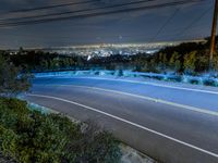 a night shot of a city from the top of a hill with long exposures of light streaks