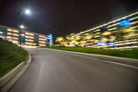 the view of a car's front wheel as it speeds on a highway at night