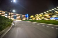 the view of a car's front wheel as it speeds on a highway at night