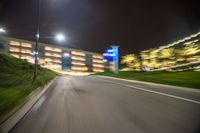 the view of a car's front wheel as it speeds on a highway at night